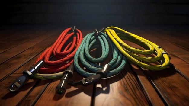 A collection of high-quality guitar cables laid out on a wooden surface, showcasing different colors and connectors, with a focus on the variety and build quality.