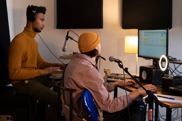 Musicians, songwriters and record producers at a recording studio during a recording session.