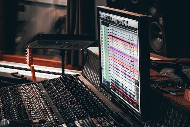 A photo of a modern recording studio setup with a computer screen displaying music production software, a mixing console, and various instruments.