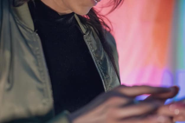 A close-up shot of a person holding a smartphone at a concert, with the phone's screen displaying a live video recording. The background shows blurry figures of other concert attendees and stage lights.