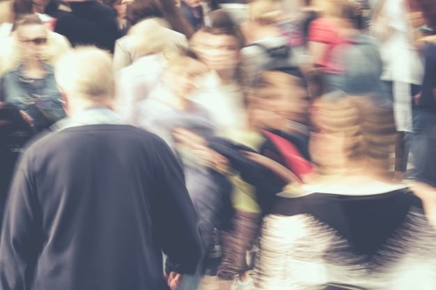 A wide shot of a concert crowd, showing people of different ages and backgrounds enjoying the music. Some are dancing and singing along, while others are standing and watching the performance. The overall atmosphere is positive and inclusive.