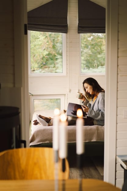 The interior of a cozy Airbnb apartment, featuring a comfortable living area and a small kitchenette. The room is decorated in a modern style with natural light coming through the windows.