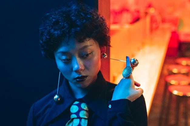 A person inserting high-fidelity musicians' earplugs into their ears, with a focus on the ergonomic design and ease of use. The background is a dimly lit concert scene.