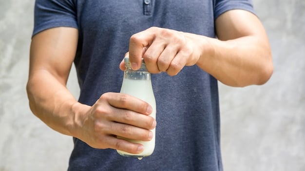 A close-up of a hand holding a bottle of electrolyte-rich sports drink at a concert, emphasizing the importance of replenishing essential minerals lost through sweat during the event.