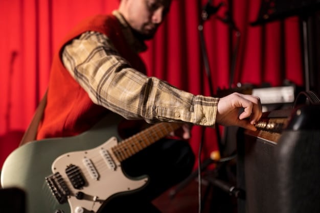 A close-up studio shot of the veteran rock band recording their new album. The focus is on the lead guitarist, who is playing a complex riff on his electric guitar. The recording equipment and soundproofing panels are visible in the background.