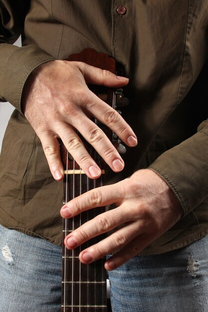 A close-up shot of the lead guitarist's hands as they shred a solo during a live performance. The focus is on the dexterity and passion of the musician, with the blurred background showing the stage lights and the rapt audience.