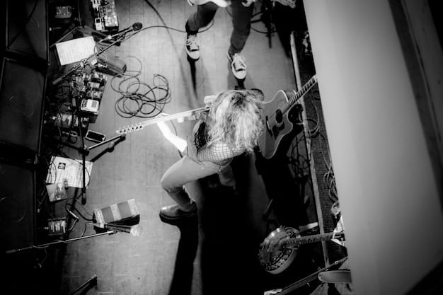 A black and white photograph of a packed, intimate venue in the unexpected US city, with a local indie band performing passionately on stage, capturing the energy and raw emotion of the scene.