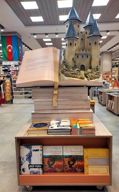 A photograph of a modern bookstore featuring a prominent display of rock star memoirs. Customers are seen browsing the shelves, and the display is well-lit and inviting. The covers of several memoirs are visible, showcasing the variety of artists and stories available.