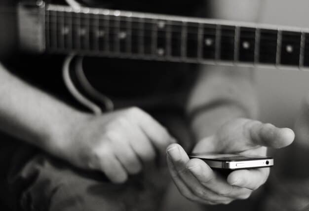A close-up of a smartphone screen showing a rock band's Instagram profile with a recent post about a new album release. The post features a visually appealing album cover and a caption encouraging fans to pre-order.