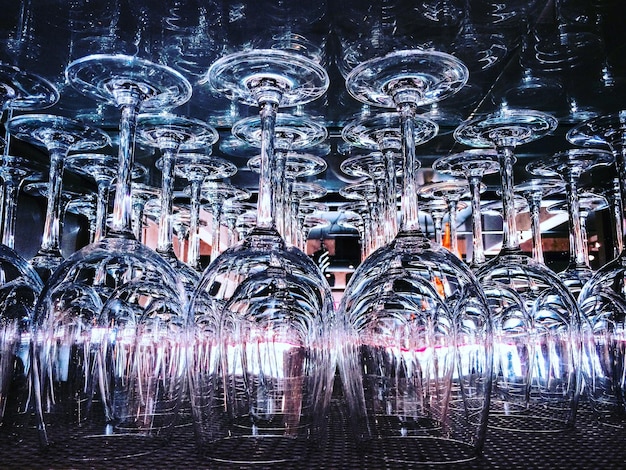 A concert stage featuring a complex array of suspended kinetic sculptures and moving light fixtures, creating a dynamic, abstract backdrop for a band performing.